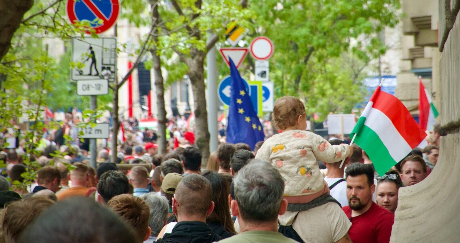 a crowd of people walking down a street