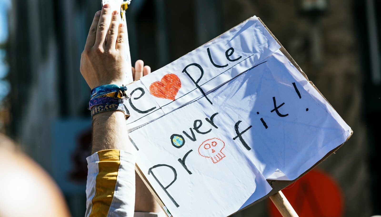 a person holding a sign that says people power it